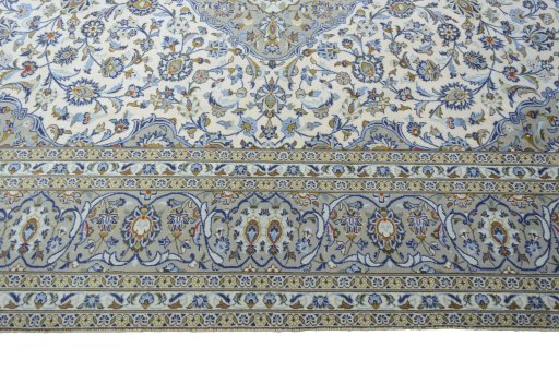 Corner detail of 2000s Kashan rug showing border pattern and Wool pile