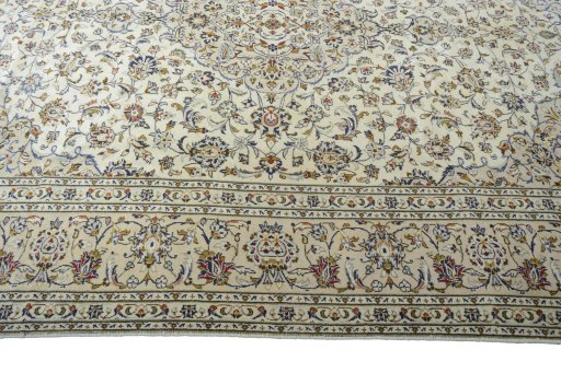 Corner detail of 2000s Kashan rug showing border pattern and Wool pile