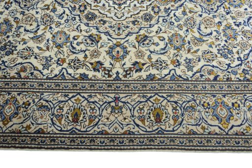 Corner detail of 2000s Kashan rug showing border pattern and Wool pile