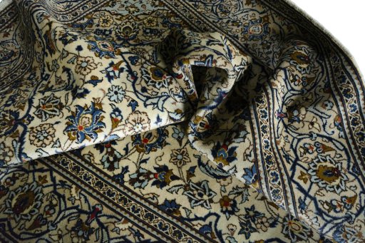 Surface texture of 2000s Kashan rug with natural Wool and intricate pattern