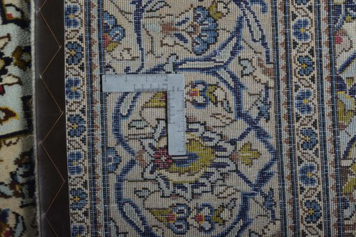 Backside of handmade 2000s Kashan rug showing knot structure and weave density