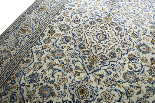 Backside of handmade 2000s Kashan rug showing knot structure and weave density