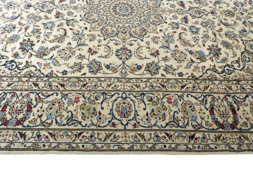 Corner detail of 2000s Kashan rug showing border pattern and Wool pile