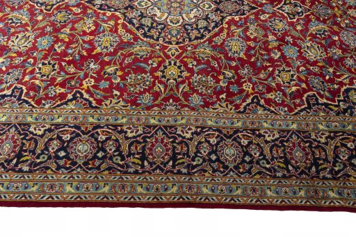 Corner detail of 2000s Kashan rug showing border pattern and Cork pile