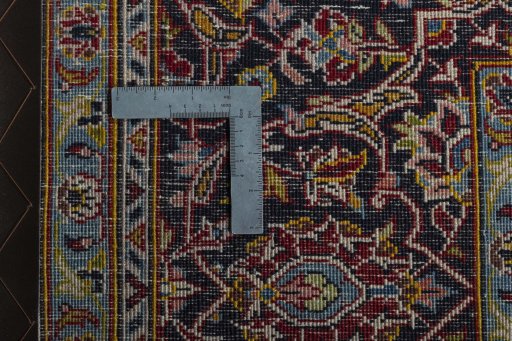 Backside of handmade 2000s Kashan rug showing knot structure and weave density