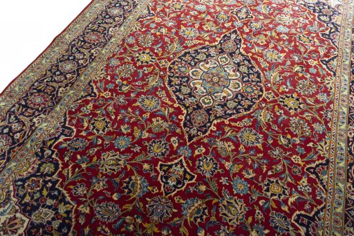 Backside of handmade 2000s Kashan rug showing knot structure and weave density