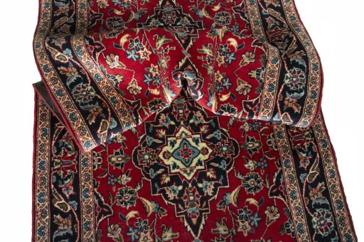 Corner detail of 2000s Kashan rug showing border pattern and Wool pile