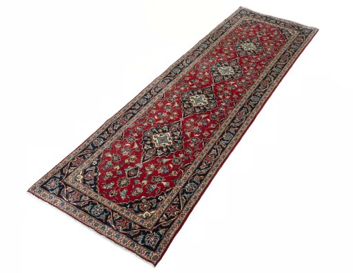 Corner detail of 2000s Kashan rug showing border pattern and Wool pile
