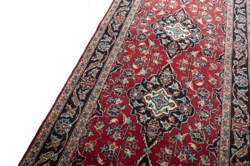 Backside of handmade 2000s Kashan rug showing knot structure and weave density