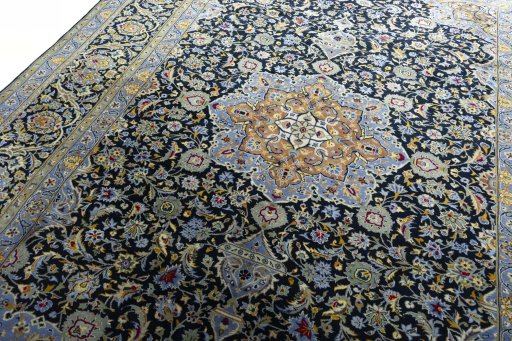 Backside of handmade New Kashan rug showing knot structure and weave density