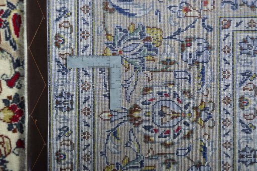 Backside of handmade 2000s Kashan rug showing knot structure and weave density