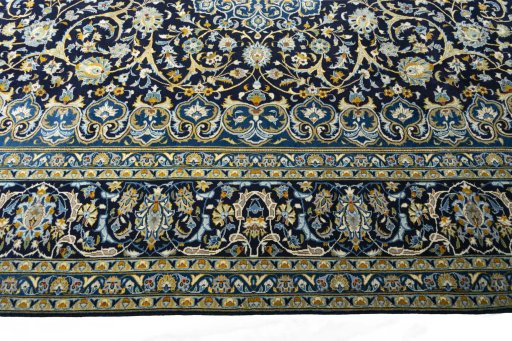 Corner detail of 2000s Kashan rug showing border pattern and Wool pile