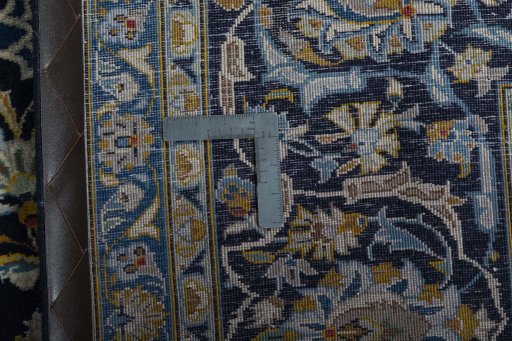 Backside of handmade 2000s Kashan rug showing knot structure and weave density