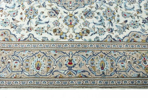 Corner detail of 2000s Kashan rug showing border pattern and Wool pile