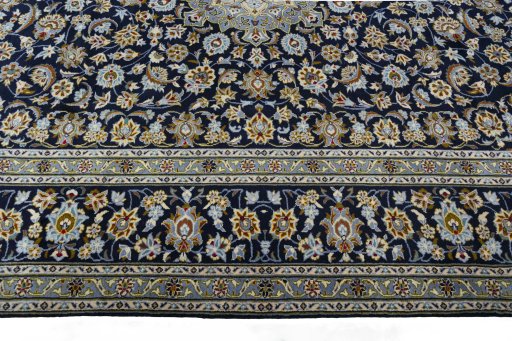 Corner detail of 2000s Kashan rug showing border pattern and Wool pile