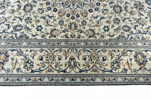 Corner detail of 2000s Kashan rug showing border pattern and Wool pile