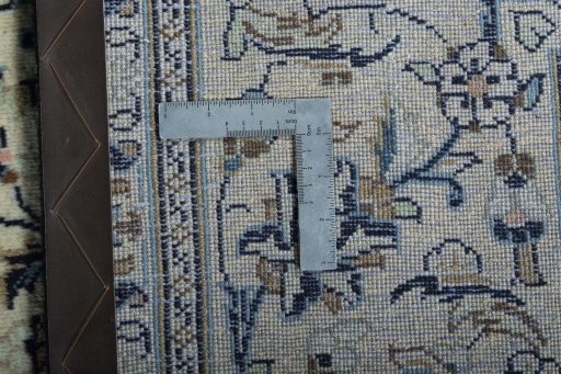 Backside of handmade 2000s Kashan rug showing knot structure and weave density