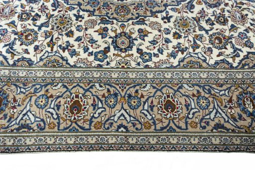 Corner detail of 2000s Kashan rug showing border pattern and Wool pile