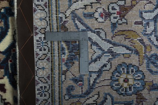 Backside of handmade 2000s Kashan rug showing knot structure and weave density