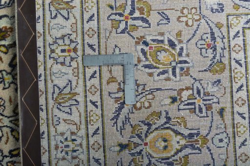 Backside of handmade 2000s Kashan rug showing knot structure and weave density
