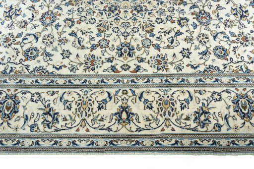 Corner detail of 2000s Kashan rug showing border pattern and Wool pile