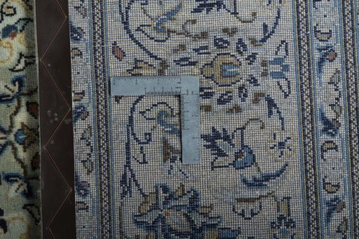 Backside of handmade 2000s Kashan rug showing knot structure and weave density