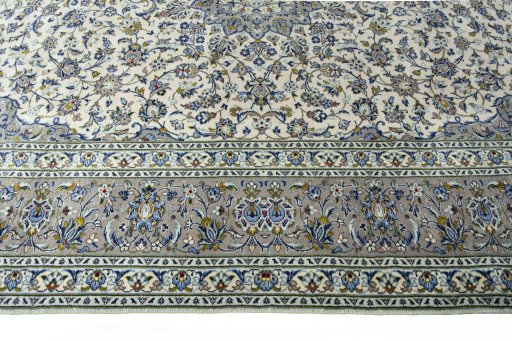 Corner detail of 2000s Kashan rug showing border pattern and Wool pile