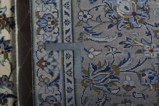 Backside of handmade 2000s Kashan rug showing knot structure and weave density