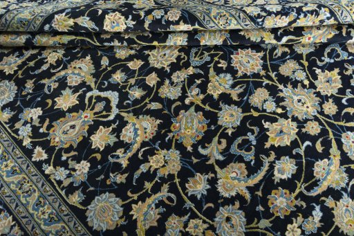Corner detail of 2000s Kashan rug showing border pattern and Wool pile