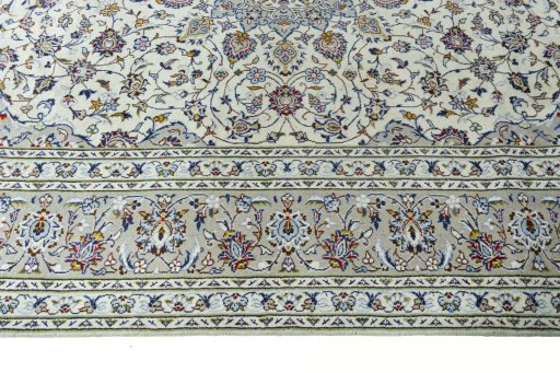 Corner detail of 2000s Kashan rug showing border pattern and Wool pile