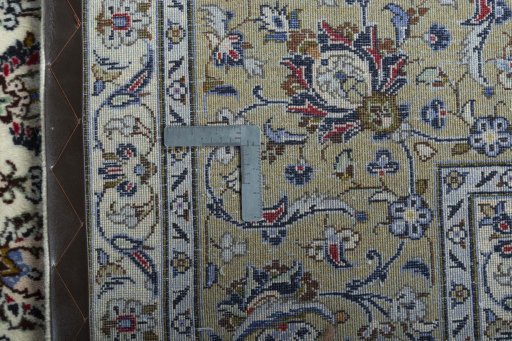 Backside of handmade 2000s Kashan rug showing knot structure and weave density