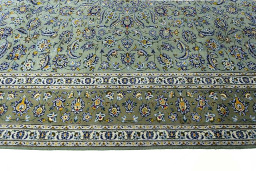 Corner detail of 2000s Kashan rug showing border pattern and Wool pile