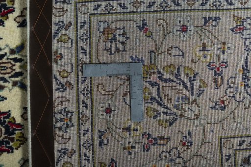 Backside of handmade New Kashan rug showing knot structure and weave density