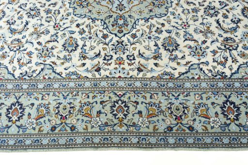 Corner detail of 2000s Kashan rug showing border pattern and Wool pile