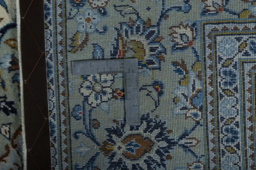 Backside of handmade 2000s Kashan rug showing knot structure and weave density