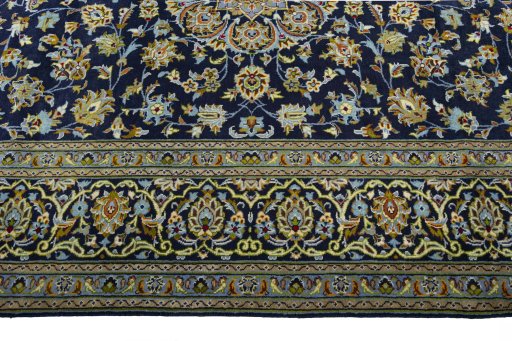 Corner detail of 2000s Kashan rug showing border pattern and Wool pile
