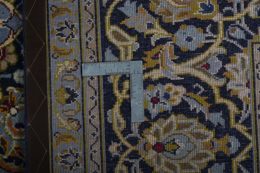 Backside of handmade 2000s Kashan rug showing knot structure and weave density