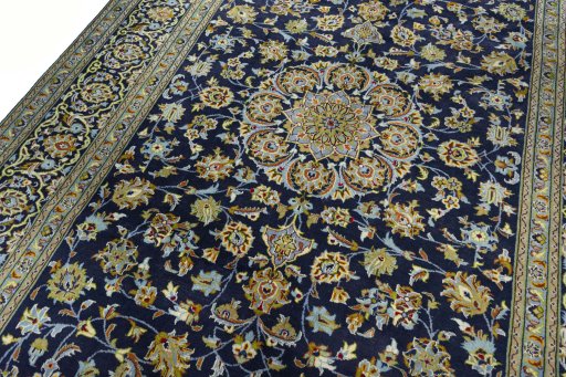 Backside of handmade 2000s Kashan rug showing knot structure and weave density