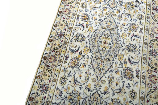 Backside of handmade New Kashan rug showing knot structure and weave density
