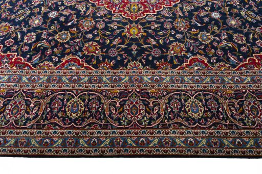 Corner detail of 2000s Kashan rug showing border pattern and Wool pile
