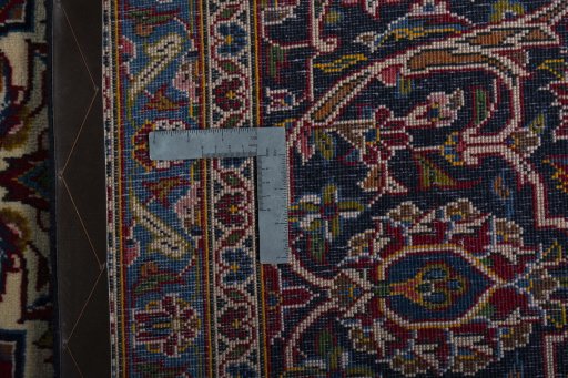 Backside of handmade 2000s Kashan rug showing knot structure and weave density