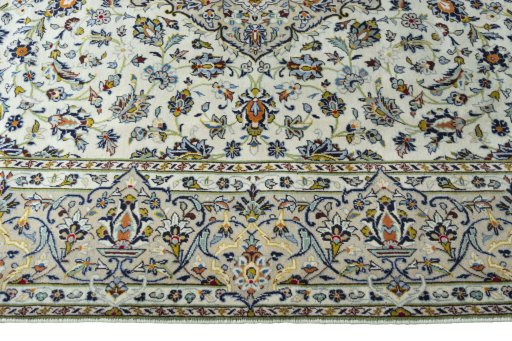 Corner detail of 2000s Kashan rug showing border pattern and Wool pile