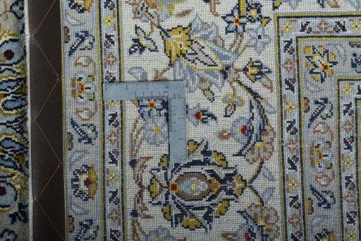 Backside of handmade New Kashan rug showing knot structure and weave density