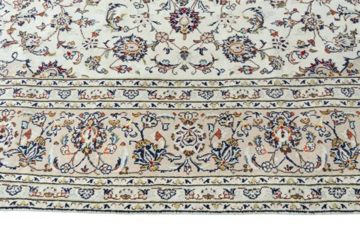 Corner detail of 2000s Kashan rug showing border pattern and Wool pile