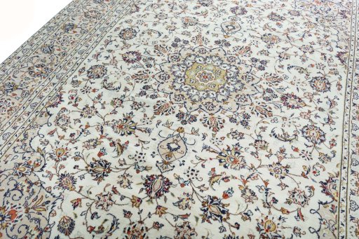 Backside of handmade 2000s Kashan rug showing knot structure and weave density