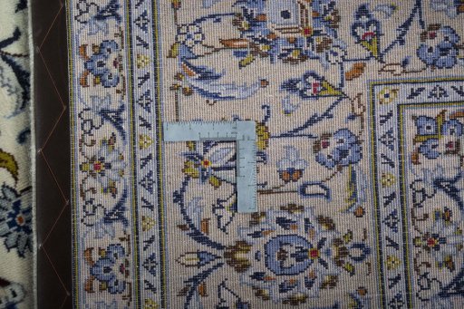 Backside of handmade 2000s Kashan rug showing knot structure and weave density