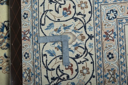 Backside of handmade 2000s Kashan rug showing knot structure and weave density