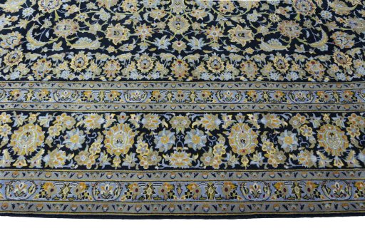 Corner detail of 2000s Kashan rug showing border pattern and Wool pile