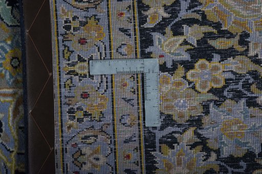 Backside of handmade 2000s Kashan rug showing knot structure and weave density