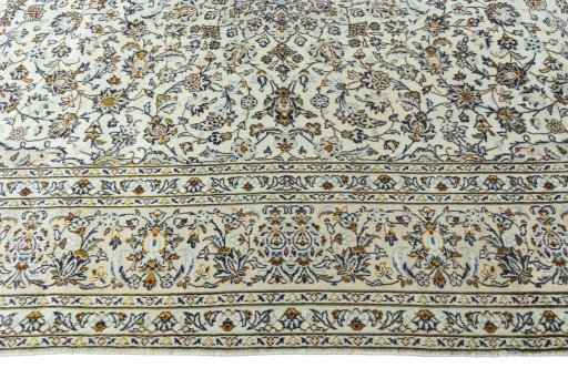 Corner detail of 2000s Kashan rug showing border pattern and Wool pile